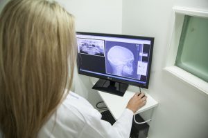 Dentist looking at X-Ray of jaw